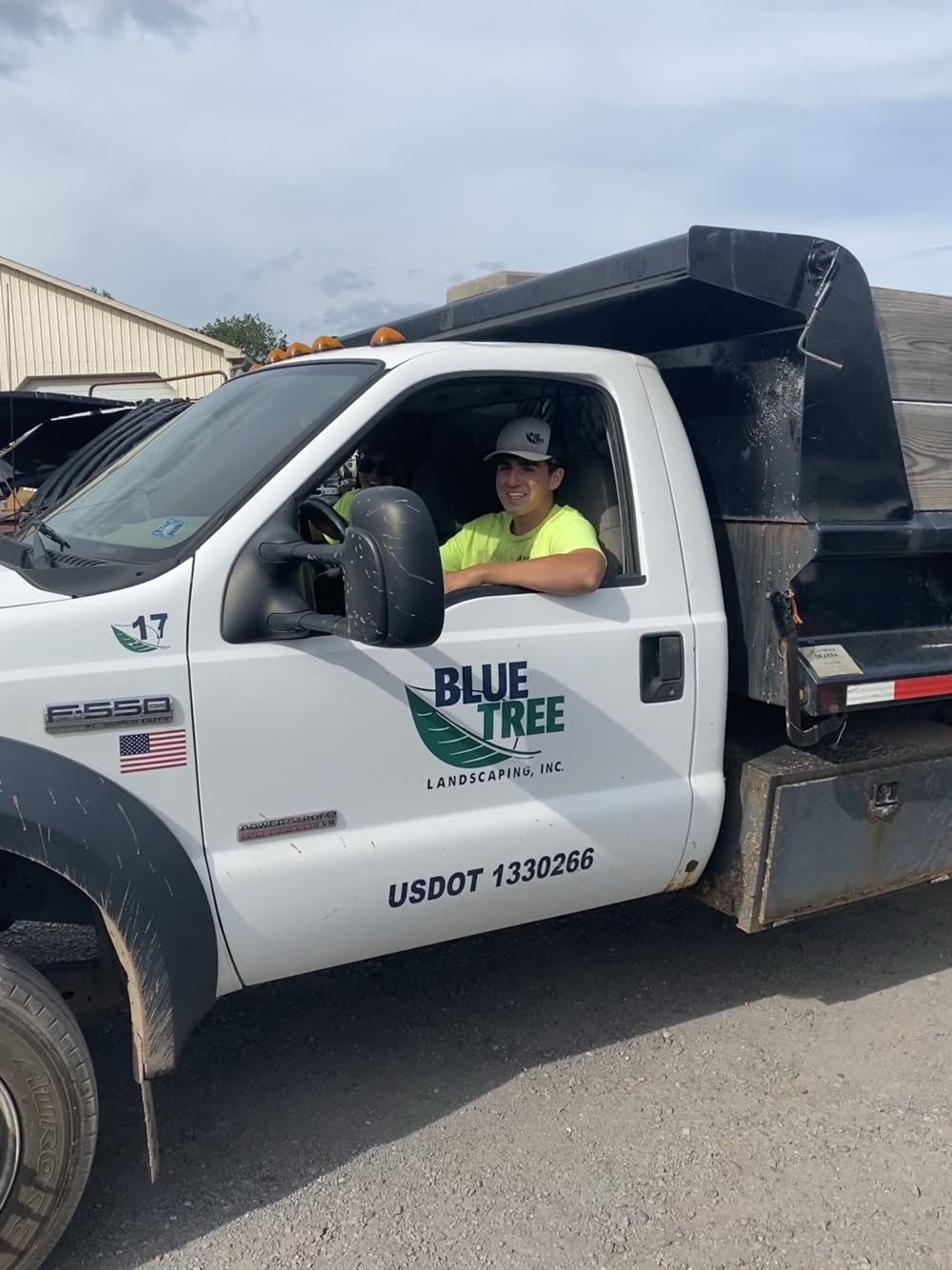 Blue Tree branded truck with a crew member on site.